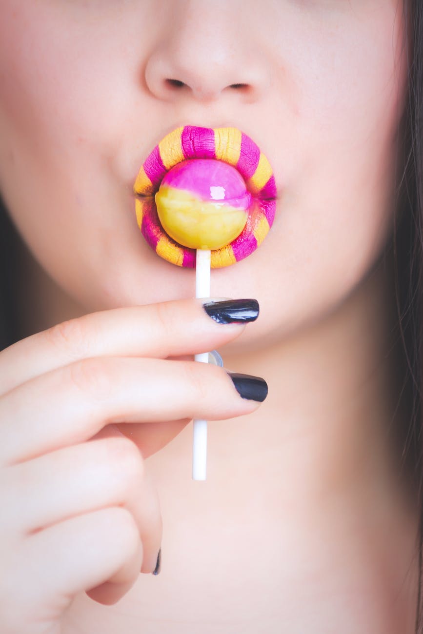 female-licking-pink-yellow-lollipop.jpg
